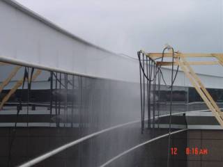 Spray rack used for controlled wetting of exterior walls
